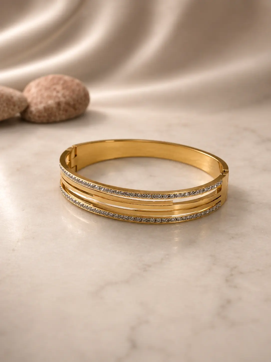 gold tone layered stone bangle with clear accent rows
