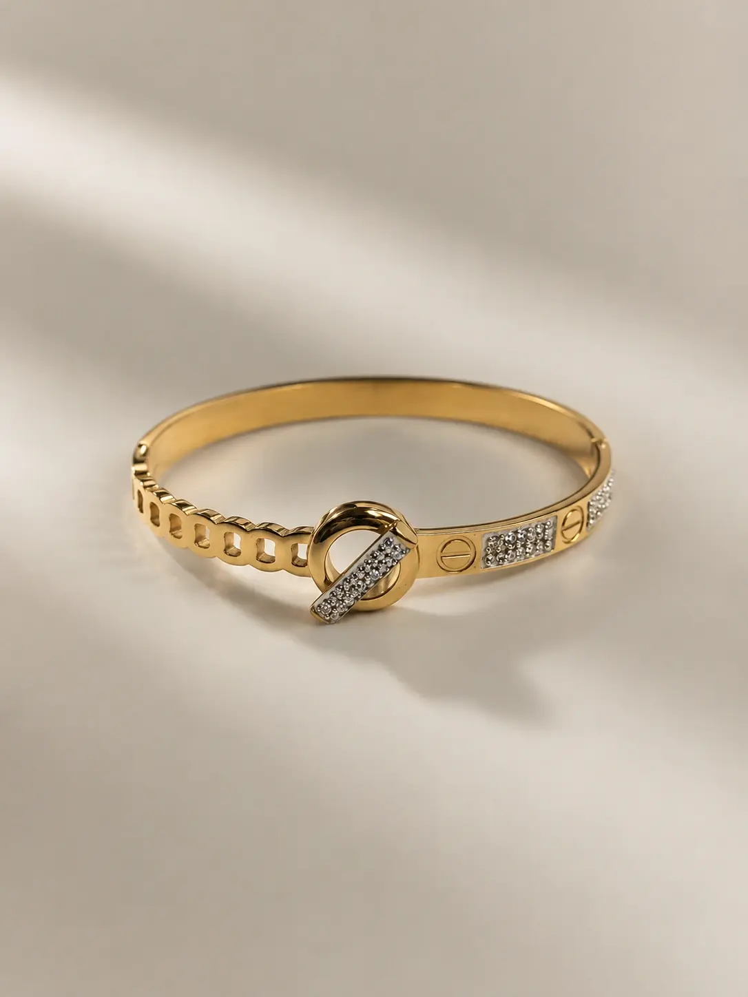gold tone knot clasp stone hinged bangle with clear accents