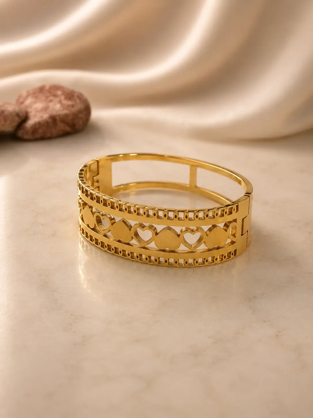 gold tone heart openwork hinged cuff bracelet with geometric borders