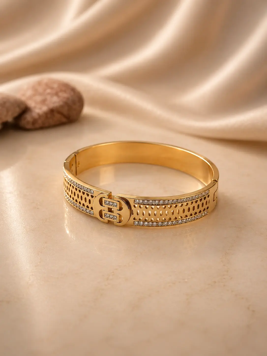 gold tone monogram openwork stone bangle with clear accents