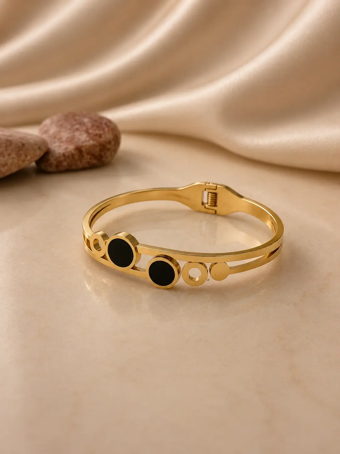 gold tone double black circle hinged bangle with geometric accents
