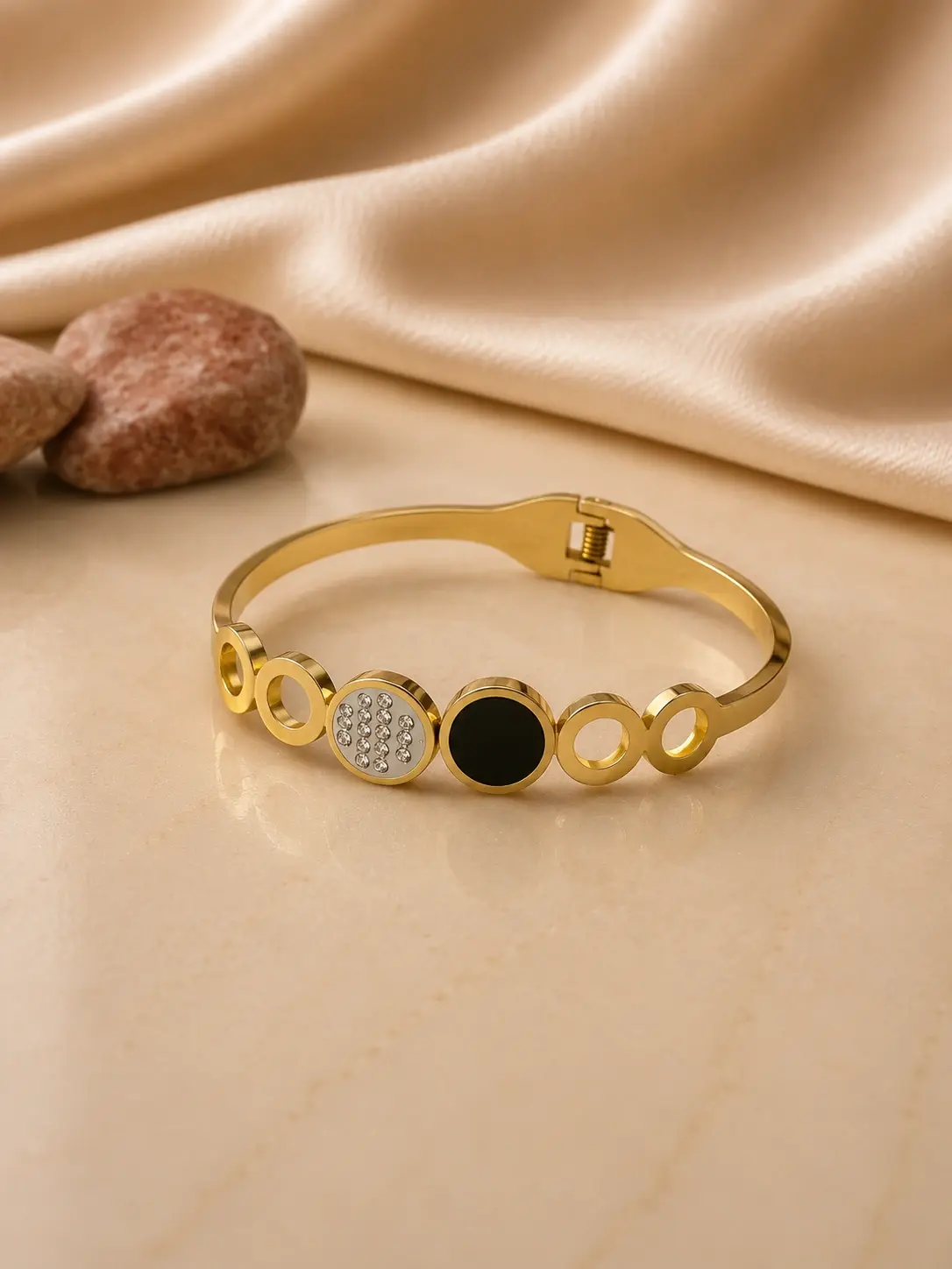 gold tone black and clear accent circle bangle with hinged closure