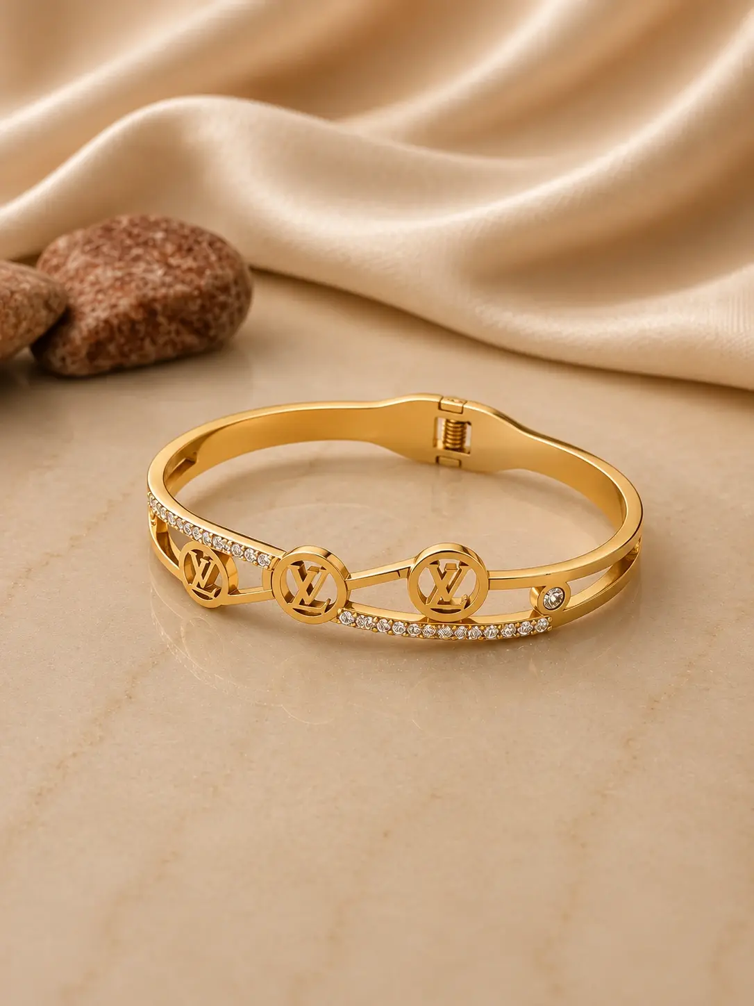 gold tone triple monogram stone hinged bangle with clear accents