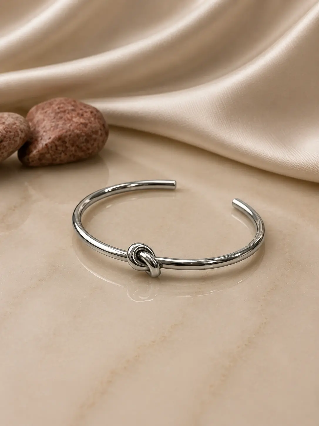 silver tone knot open cuff bracelet with interlocking center design