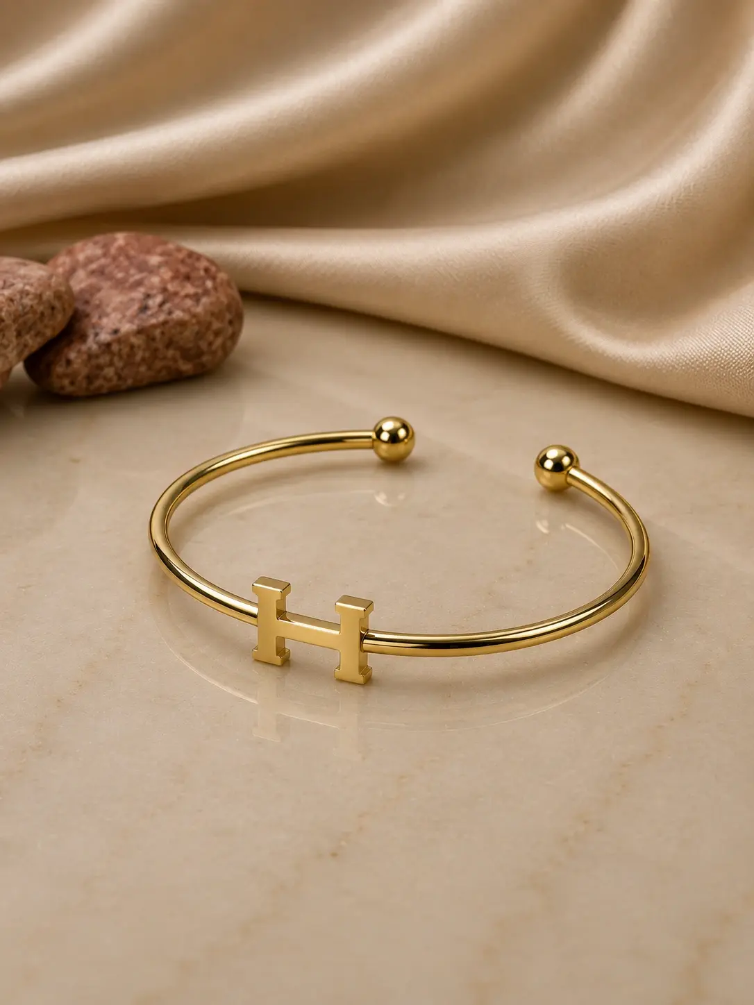 gold tone H initial open cuff bracelet with polished ball ends