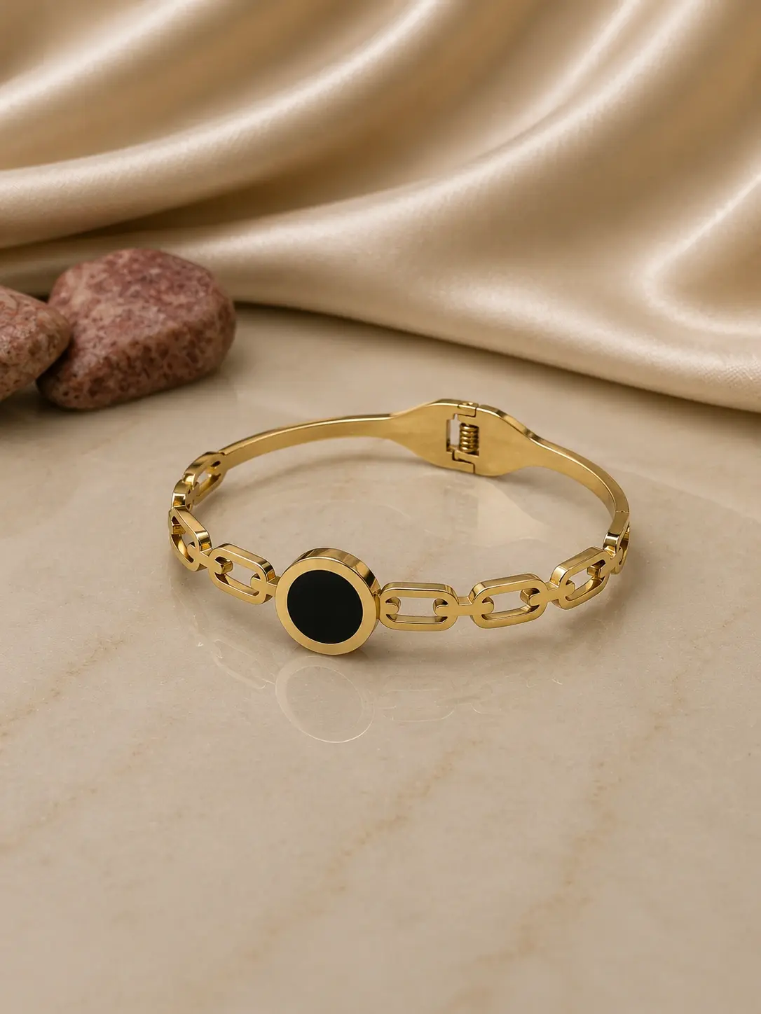 gold tone black medallion chain link bracelet with hinged closure