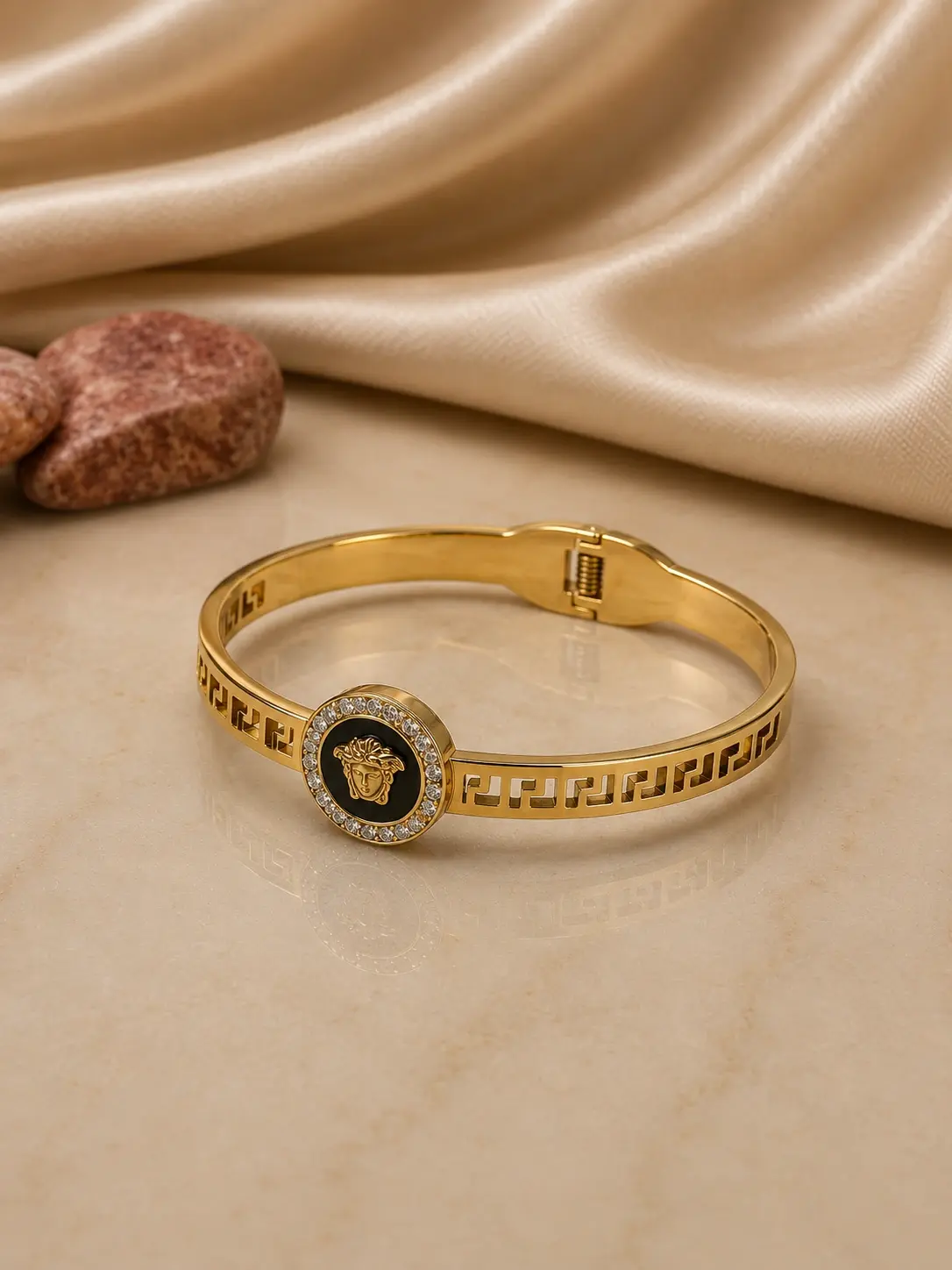 gold tone black medallion Greek key bangle with clear stone halo