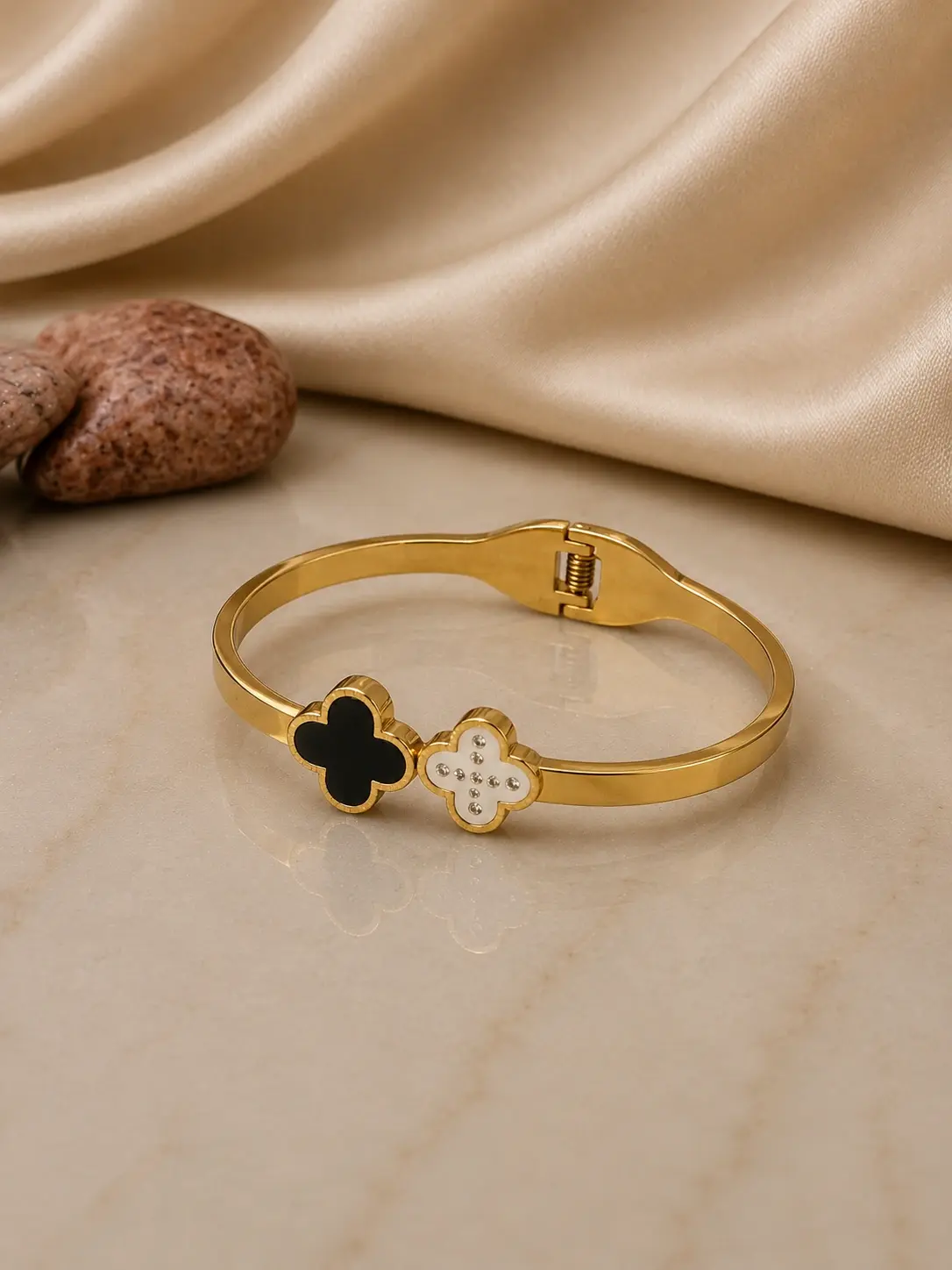 gold tone black and white clover hinged bangle with clasp closure