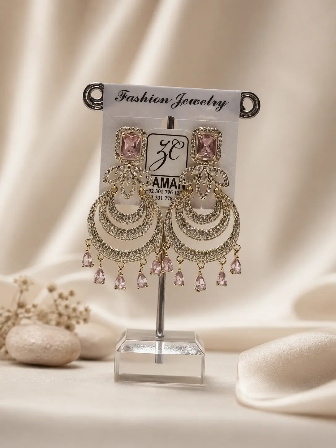 Pink Crescent Chandelier Drop Earrings with layered gold-tone bands and pale-pink teardrop details