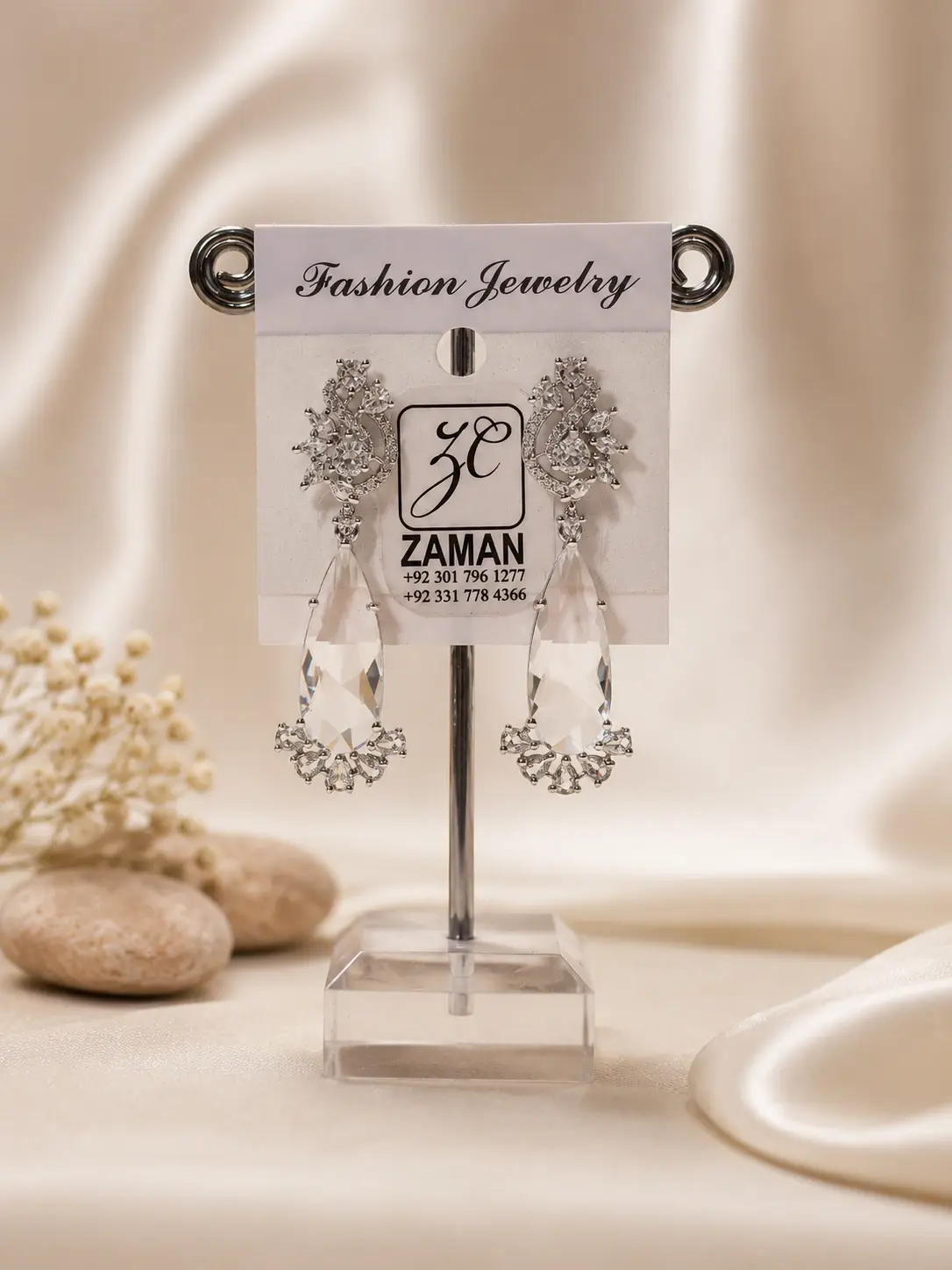 Clear Teardrop Floral Cascade Earrings with ornate leafy tops and silver-tone details