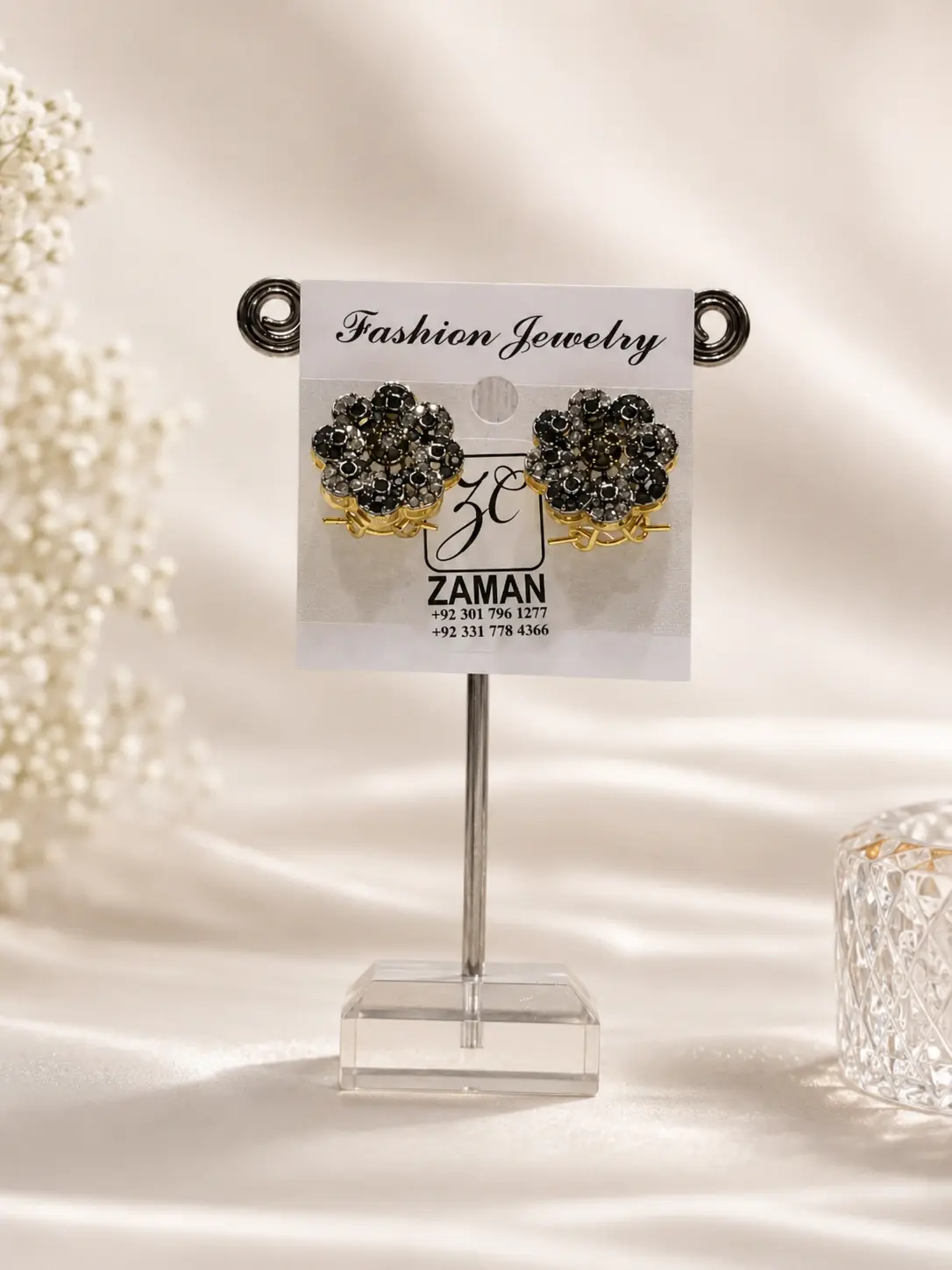Black Rosette Halo Stud Earrings with clear petal accents and warm gold-tone details