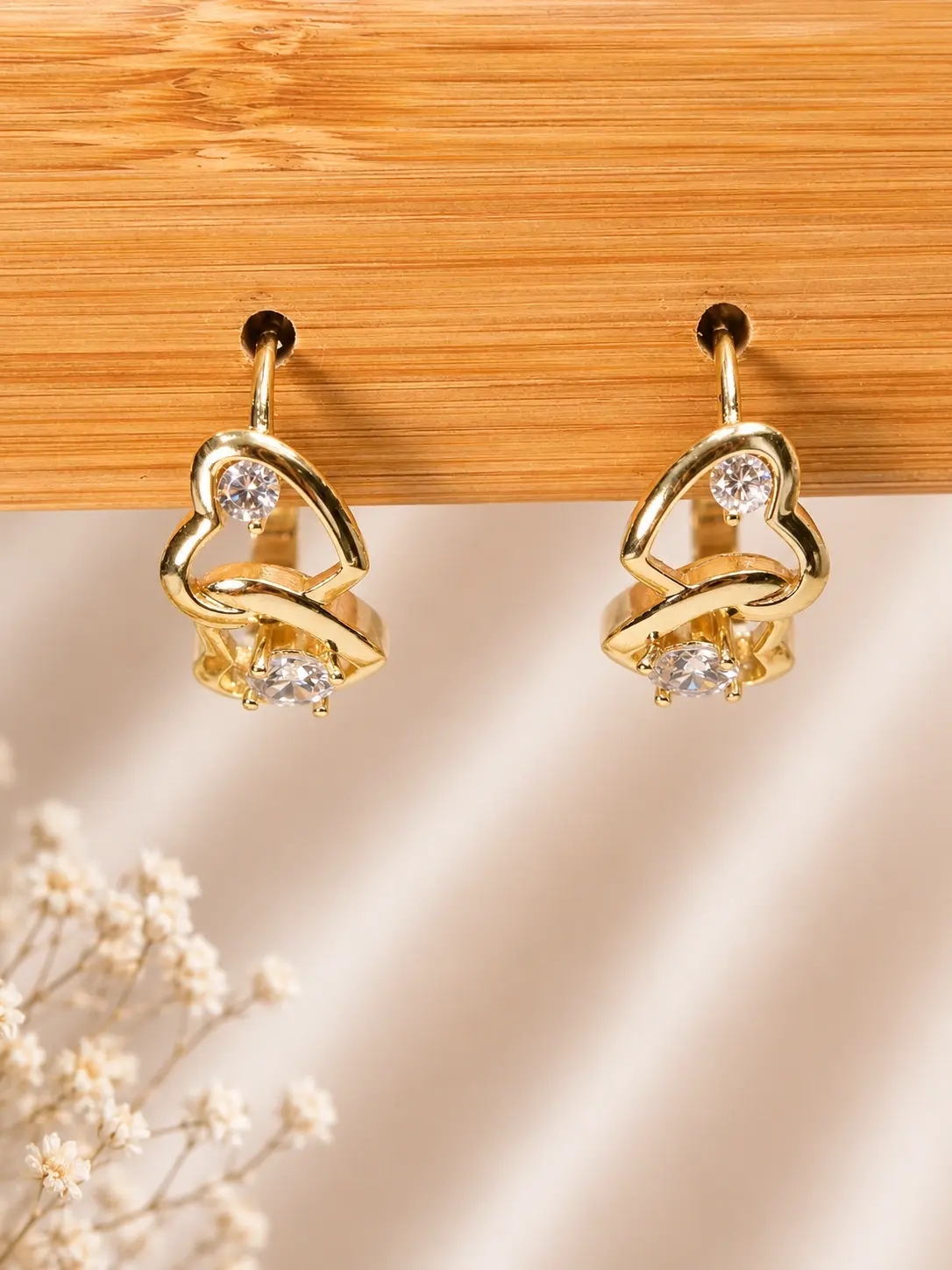 Gold Heart Loop Stone Earrings with polished curves and two clear round decorative stones