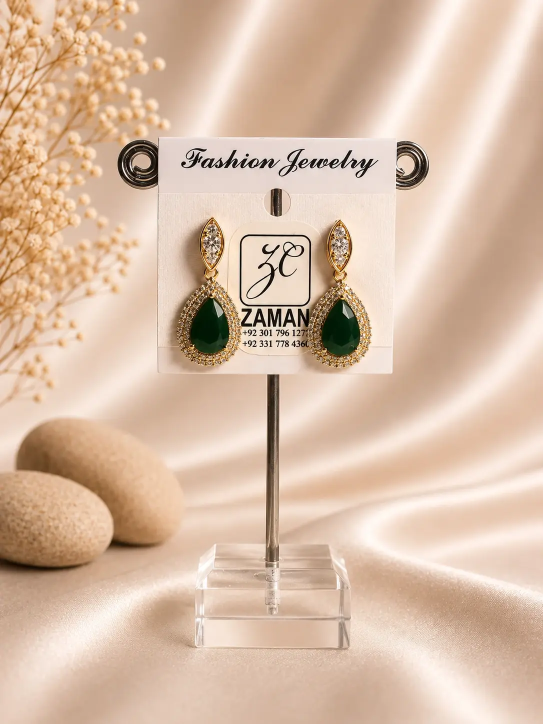 emerald green teardrop halo earrings with sparkling gold-tone frame