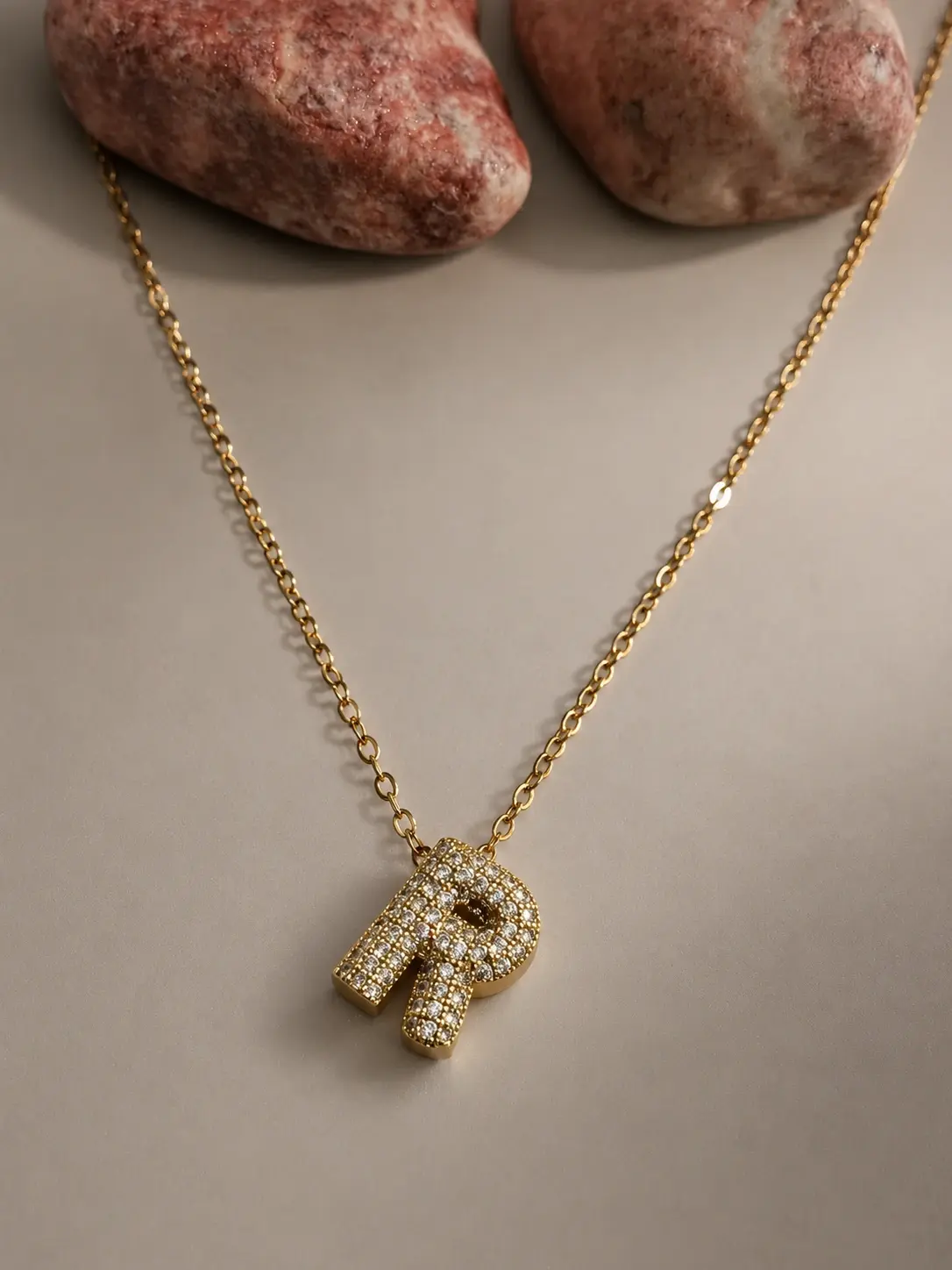 gold R initial stone necklace with sparkling letter pendant