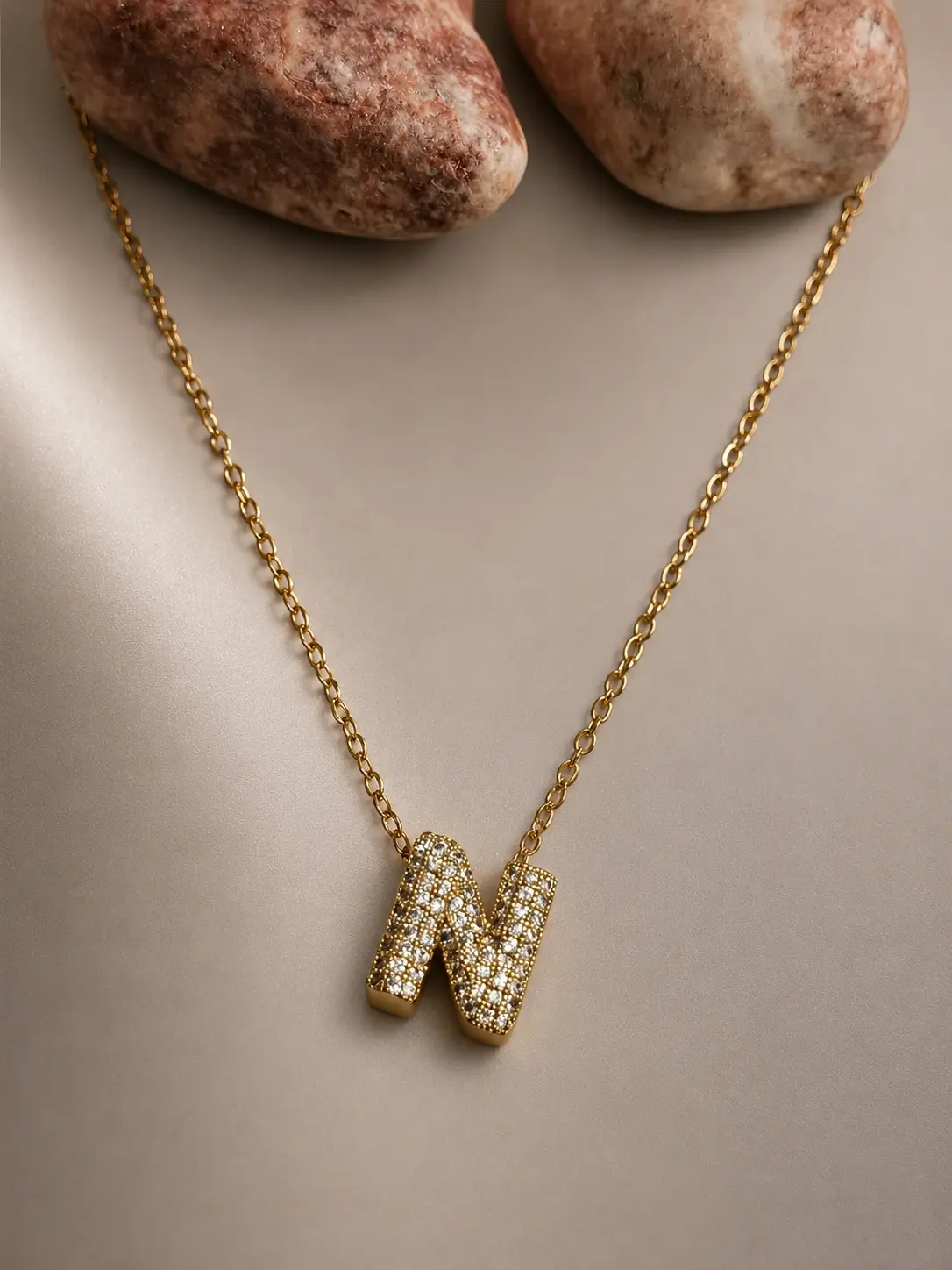 gold N initial stone necklace with sparkling letter pendant