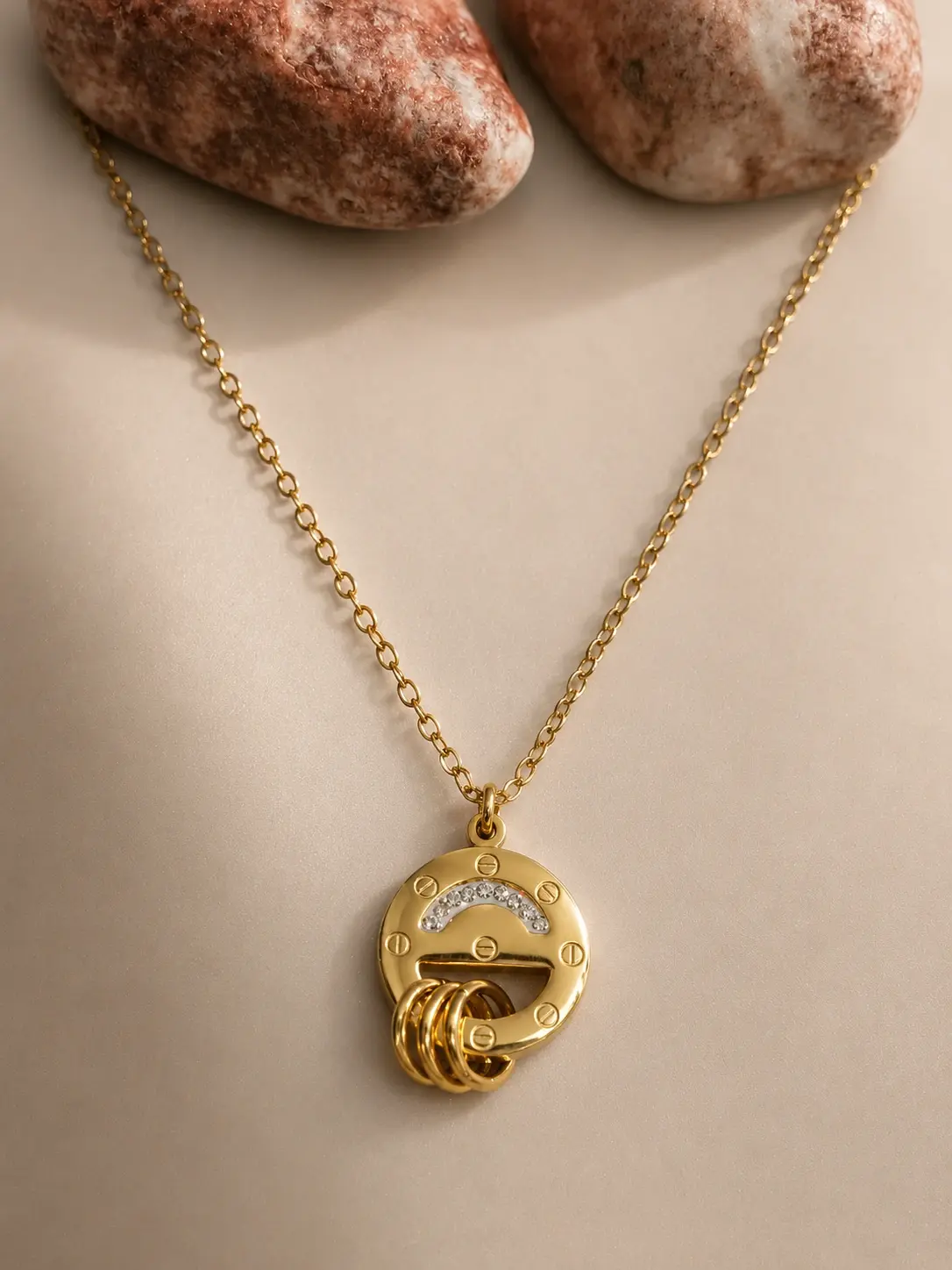 gold circular screw ring necklace with clear curved accents