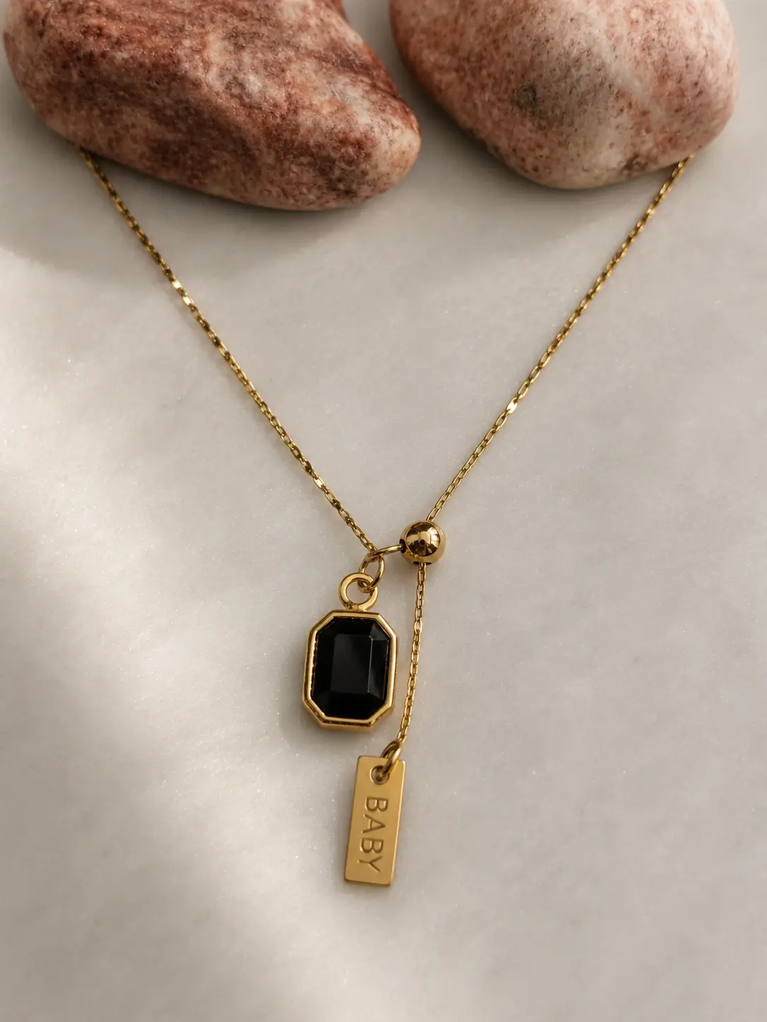 gold black baby tag necklace with rectangular black charm