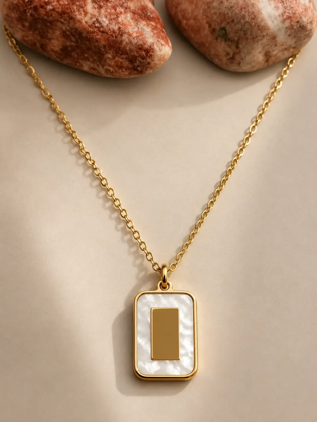 gold white rectangular necklace with raised gold centerpiece