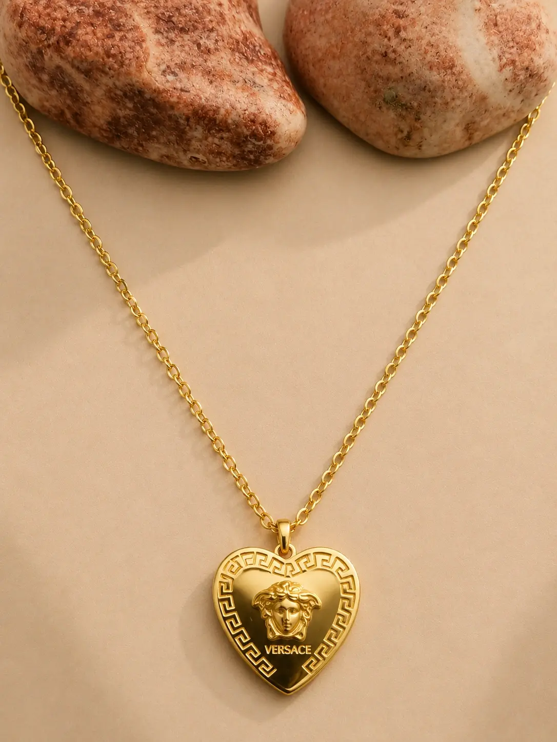 gold Greek border heart necklace with raised medallion centerpiece