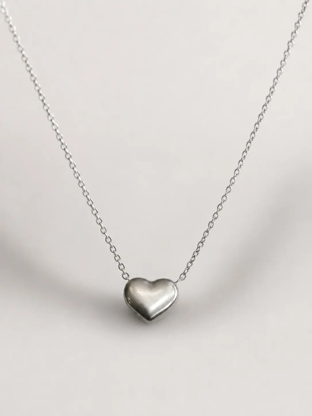 silver polished heart necklace with smooth rounded centerpiece