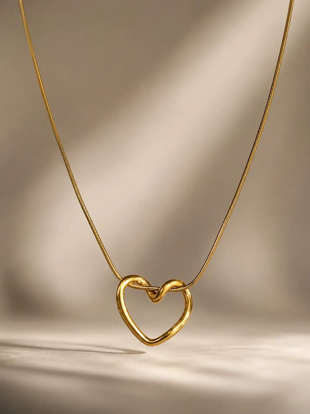 gold open heart pendant necklace with sculpted polished outline