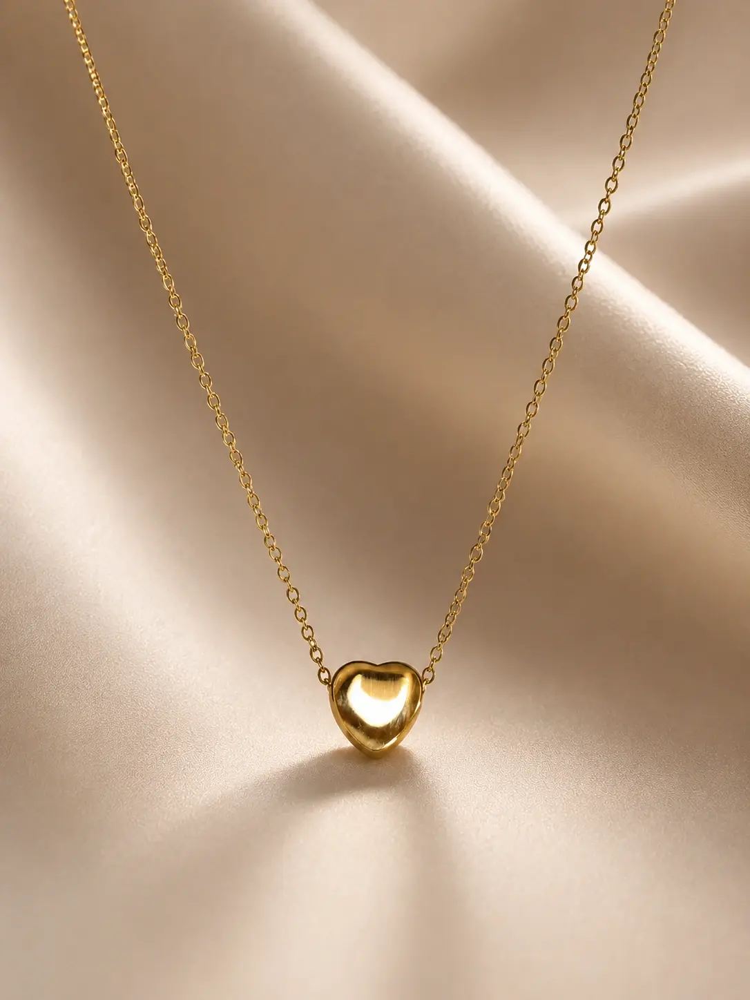 gold minimal heart necklace with polished heart centerpiece