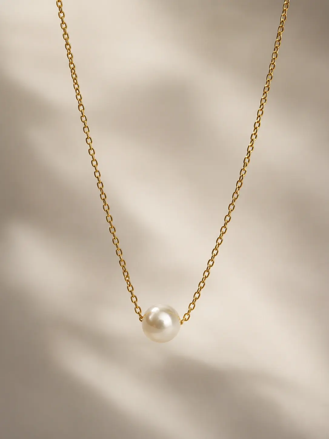 gold single pearl style necklace with ivory round bead