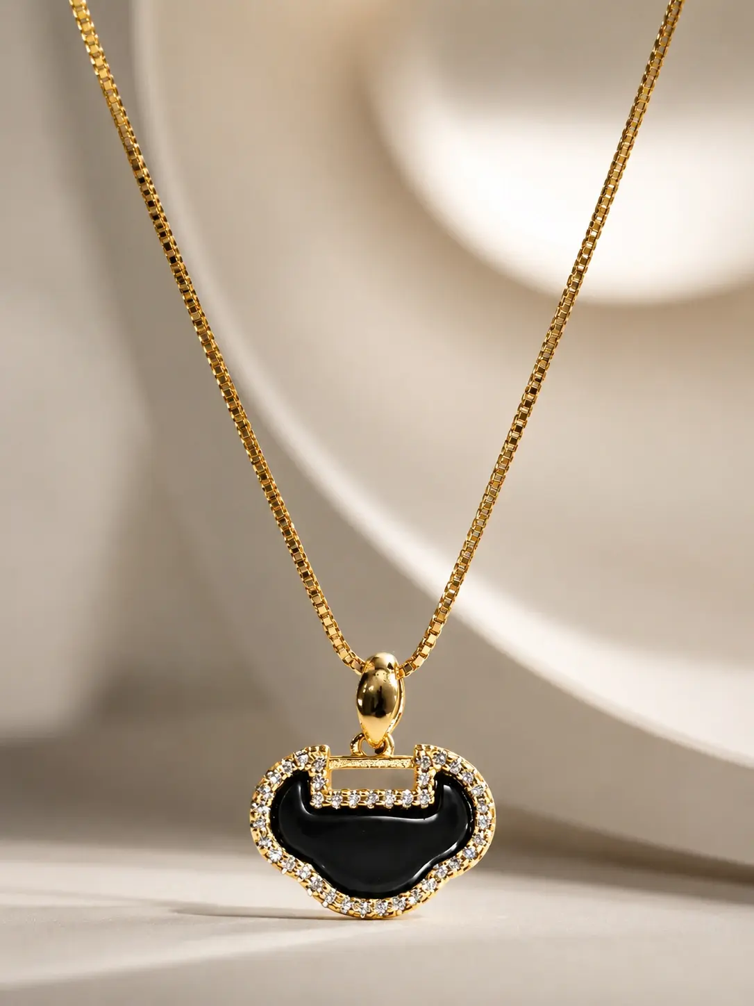 gold black crescent pendant necklace with clear accent border