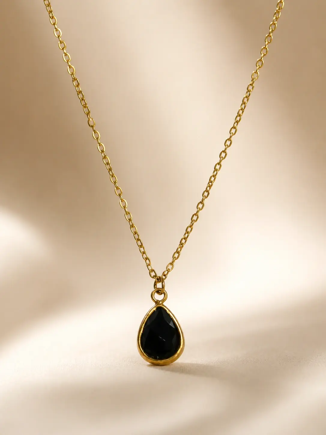 gold black teardrop pendant necklace with faceted drop centerpiece