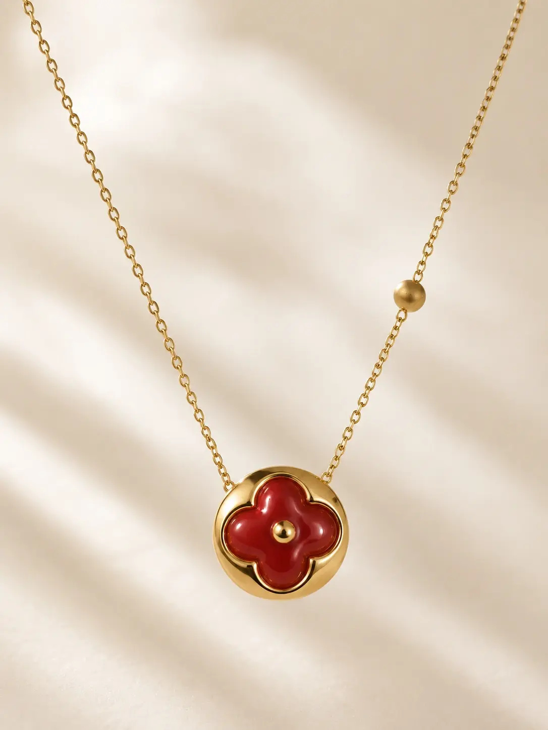 gold red clover pendant necklace with four-petal centerpiece