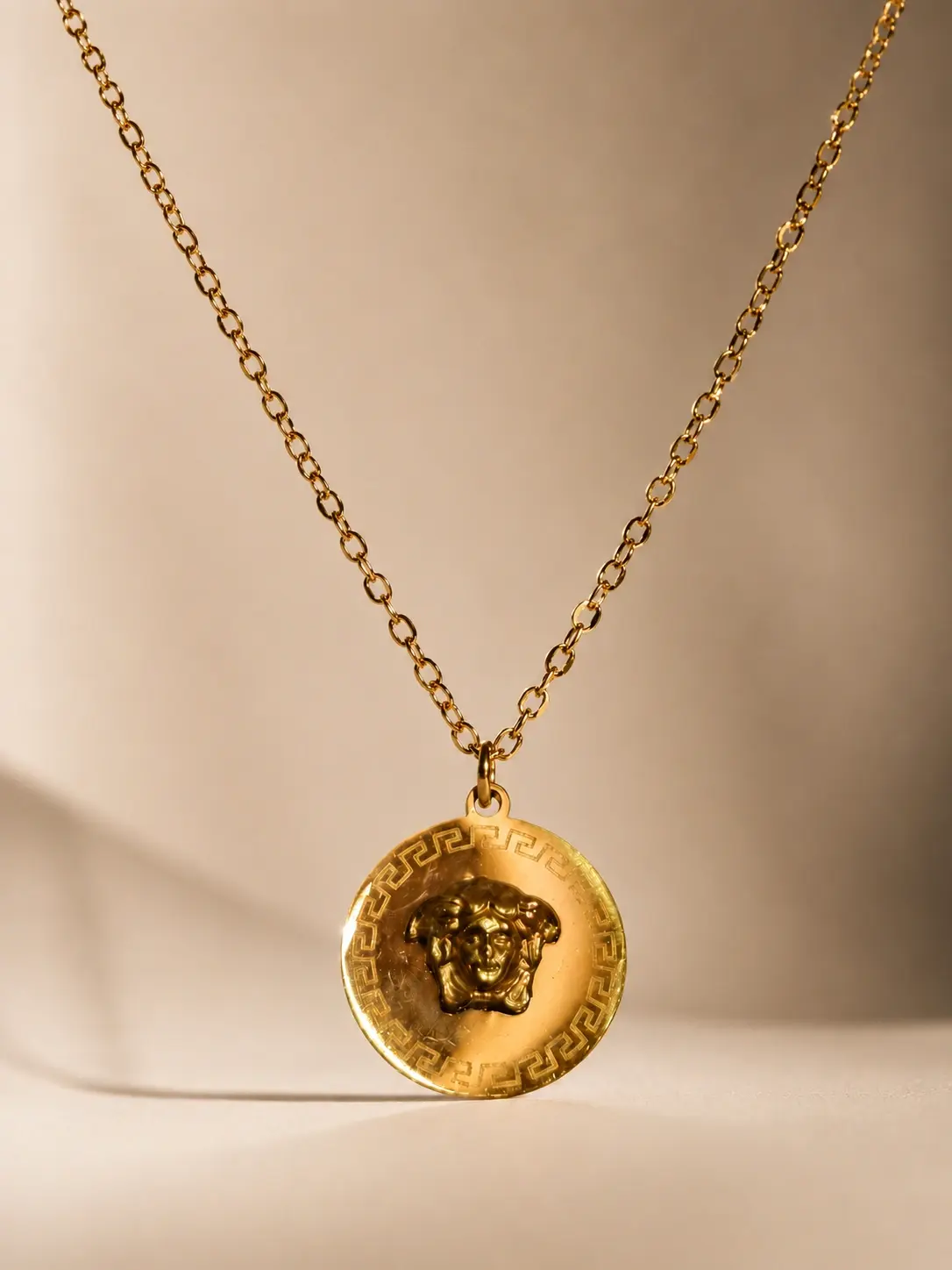 gold embossed medallion necklace with round coin pendant