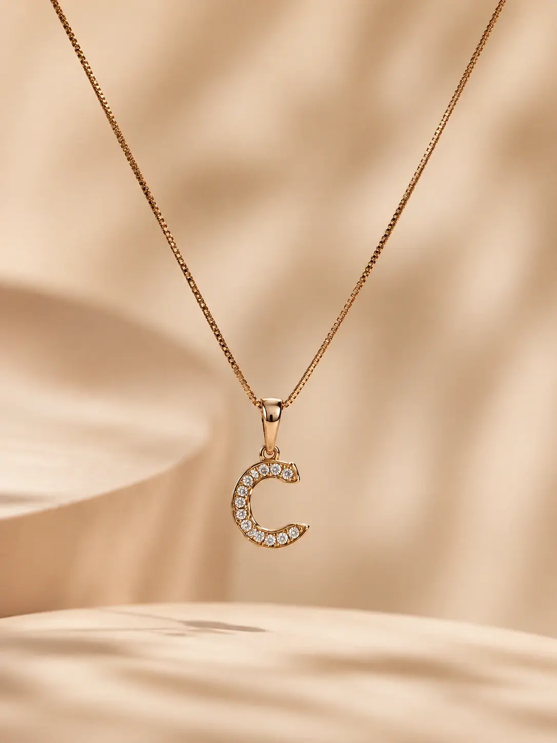 gold C initial pendant necklace with clear round accents