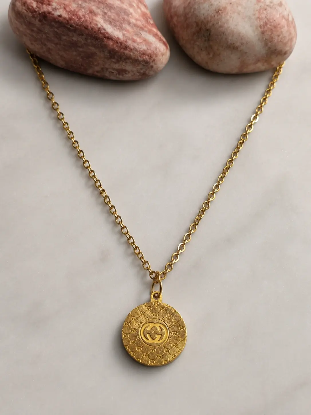 gold monogram coin necklace with round textured pendant