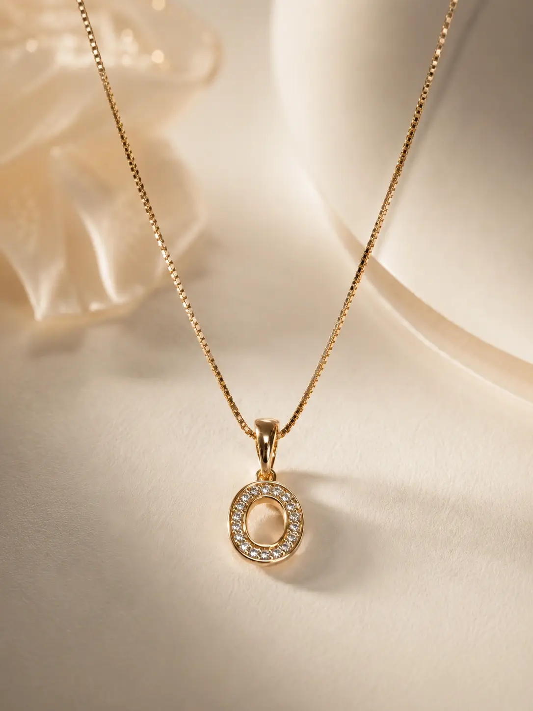 gold oval halo necklace with open center and clear accents