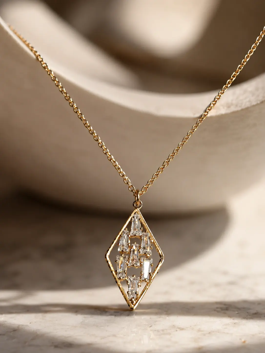 gold rhombus baguette necklace with seven clear accents