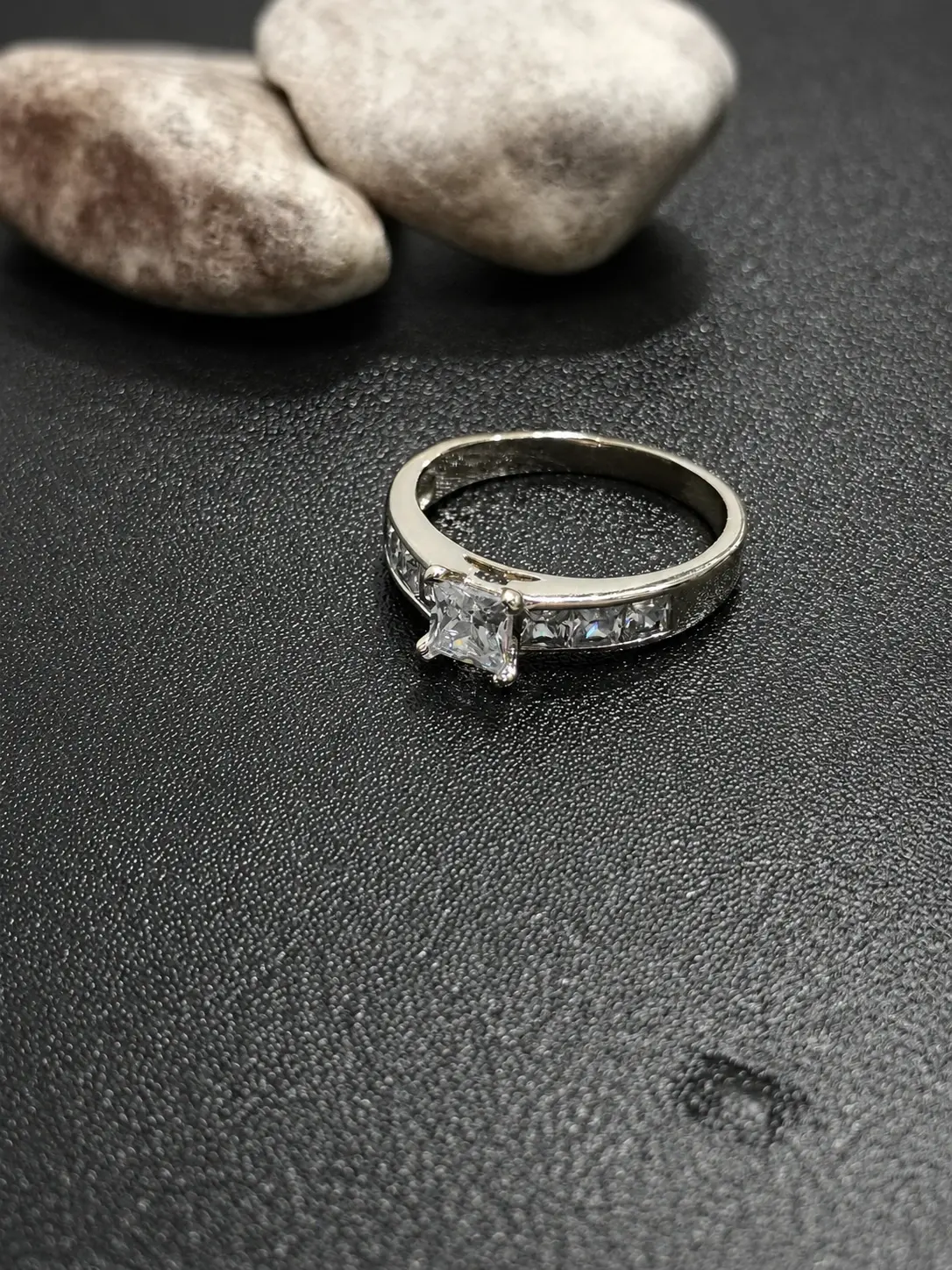 silver tone square center channel set ring with clear side stones