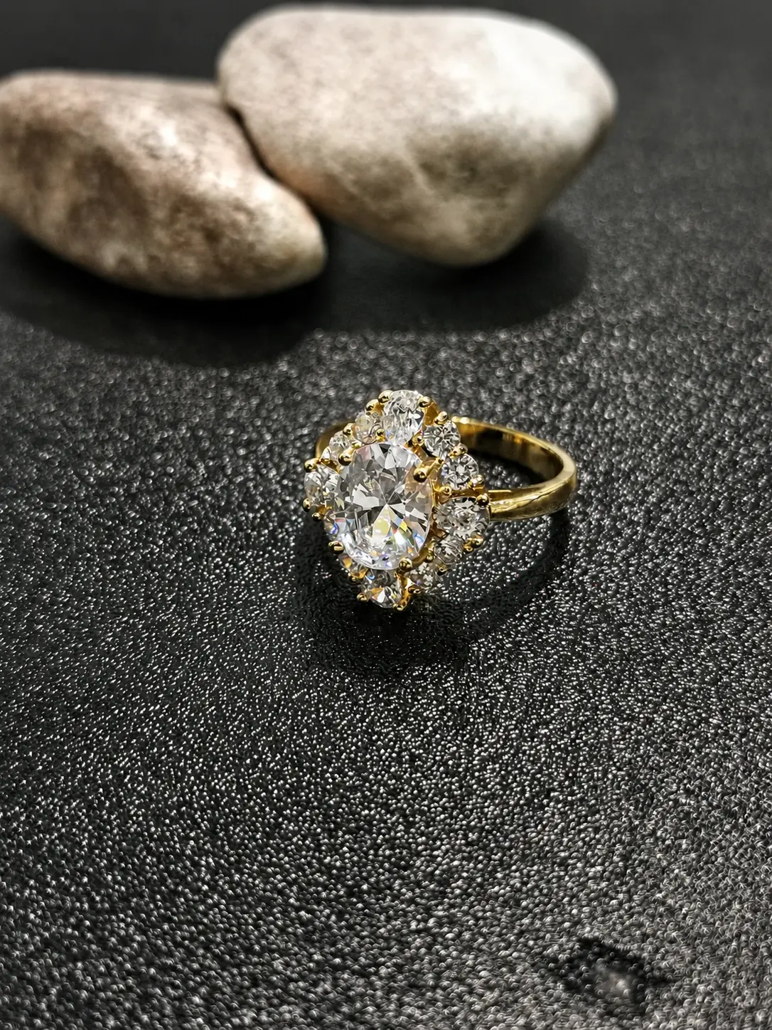 gold tone oval floral cluster ring with clear oval center stone